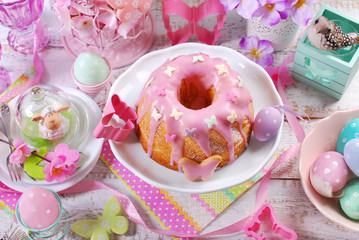 easter ring cake with pink icing and butterfly shaped sugar spri