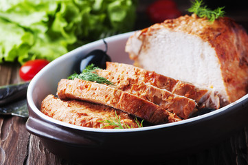 Baked meat with olive on the wooden table