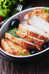 Meat with olive on the wooden table