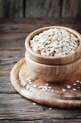 Uncooked oatmeal cereal on the wooden table