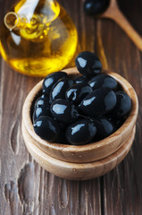 Greek black olive and oil on the wooden table