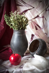 Still Life with a black jug and a red apple