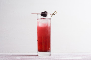 Blackberry cocktail on the wooden background