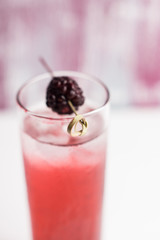 Blackberry cocktail on the wooden background. Selective focus.