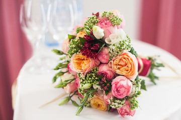 bridal bouquet of roses, buttercups and other flowers