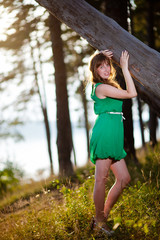 Naklejka premium Young woman outdoor.Stunning sensual outdoor portrait of young stylish fashion woman posing in summer forest