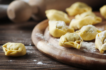 Italian traditional  tortellini on the wooden table