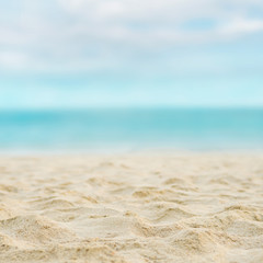 Close up sand with blurred sea sky background, summer day, copy space or for product.