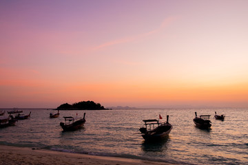 Fototapeta na wymiar Silhouette of fisherman boat floating in the sea on dramatic sun