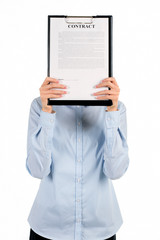 Businesswoman's face covered by clipboard.