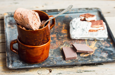 chocolate ice cream with walnuts in a coffee cup, summer dessert