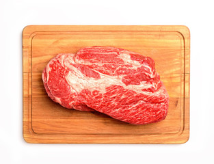 marble veal steak on a board on a white background