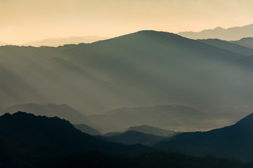 Dramatic sunset on mountain layers.