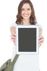 Portrait of happy female student showing tablet 