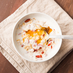 Smoothie bowl with natural yogurt, goji berries, oatmeal flakes and honey. square image