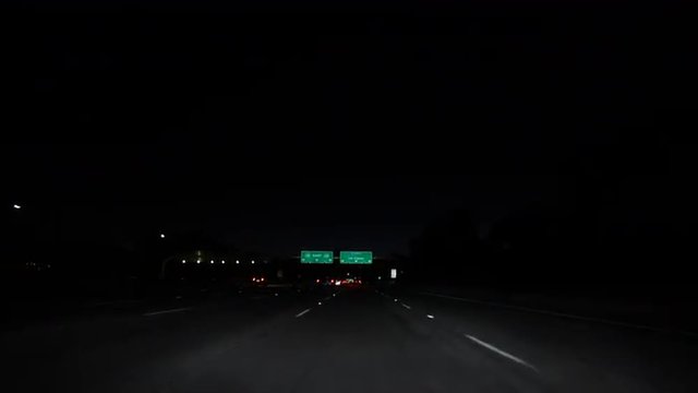 Los Angeles and Hollywood Freeway signs night driving shot.