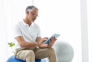 Physiotherapist using digital tablet