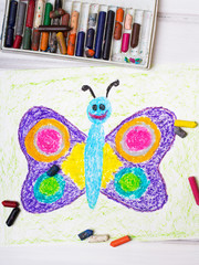 closeup of a drawing: happy butterfly with colorful wings