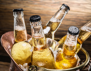 Cold bottles of beer in the brazen bucket.