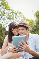 Young couple looking at digital tablet