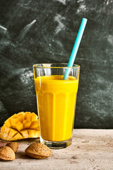 One large mango drink on rustic table