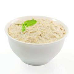 oatmeal porridge in bowl with mint in white background