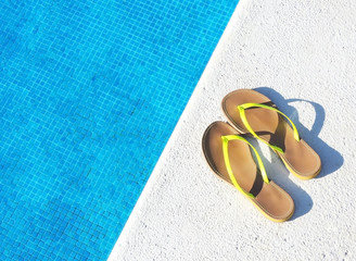 Flip Flops on the pool, summer background with copy space