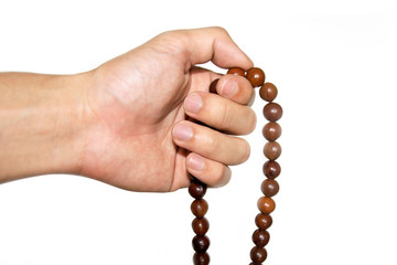 Holding Buddhist prayer beads isolate on white background © ananaline