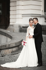 Fototapeta premium Luxury married wedding couple, bride and groom posing in old city