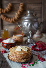 Traditional homemade slapjacks with butter, honey, milk and cottage cheese on vintage wooden table background