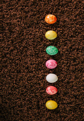 easter color eggs lying on a carpet in a row