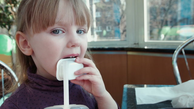 The little girl licks sauce