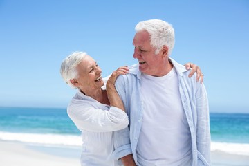 Senior couple embracing at the beach