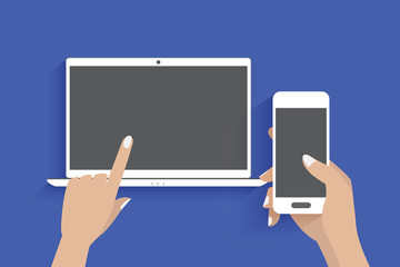 Modern laptop and hand using a smartphone, Blue background.