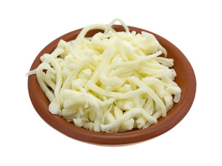 Pizza cheese in a small bowl isolated on a white background side view.