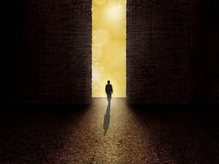 Man standing on the edge of darkness and light