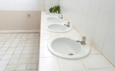  white sink, select focus front  Bathroom interior with white sink and faucet