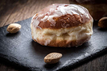 Donut with icing and rose jam.