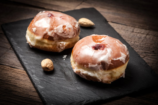 Donut with icing and rose jam.