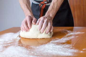 Baker makes bread on the table