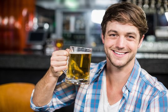 Portrait of smiling man drinking a beer