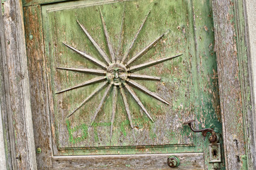 Sun symbol on old door