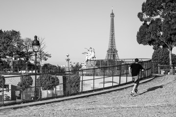Young man jogging in the morning in Tuileries Garden (black and