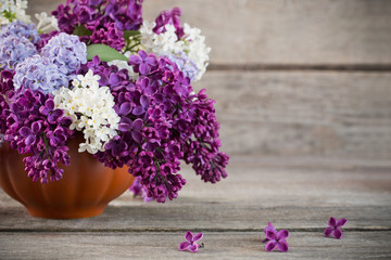 Still life with a blooming branch of lilac