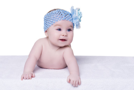 Cute Baby Smiling With Blue Bow Flower On Her Head