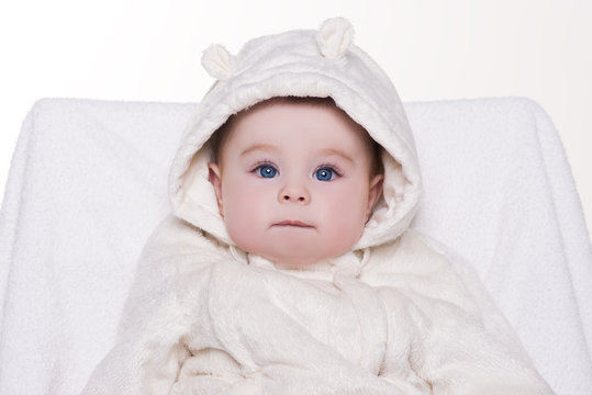 portrait of a cute baby in white hood bear