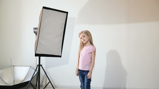 Photographer taking pictures of the child in the studio.