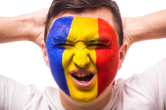 Unhappy and Failure of goal or lose game emotions of Romanian football fan in game supporting of Romania national team on grey background. European 2016 football fans concept.