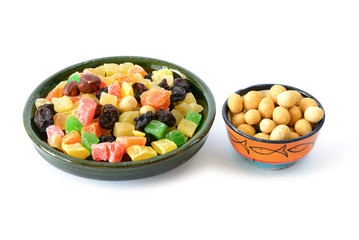 Delicious and healthy mixed dried fruit and  nuts in the bowl.  Isolated on white background