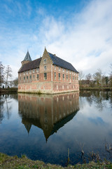 Fototapeta na wymiar Dutch medieval castle reflected in the moat